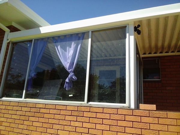 A replaced window and awning set into a brick wall