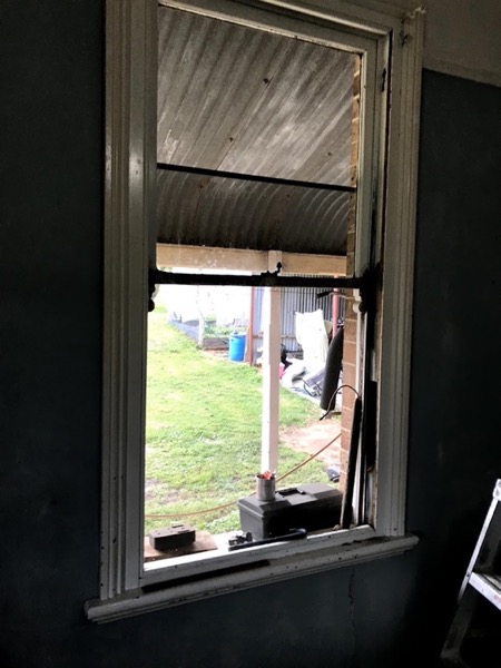 A window opening seen from inside a dark room during works