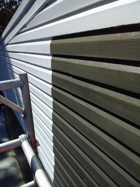 Grey wall cladding boards going up with access gear alongside