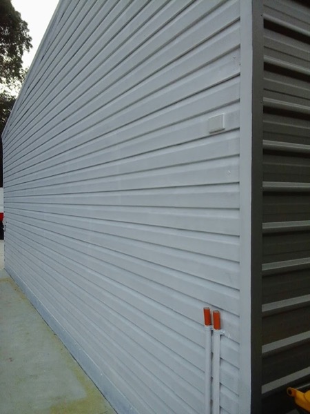 A white roller shutter closed over an opening in an exterior wall