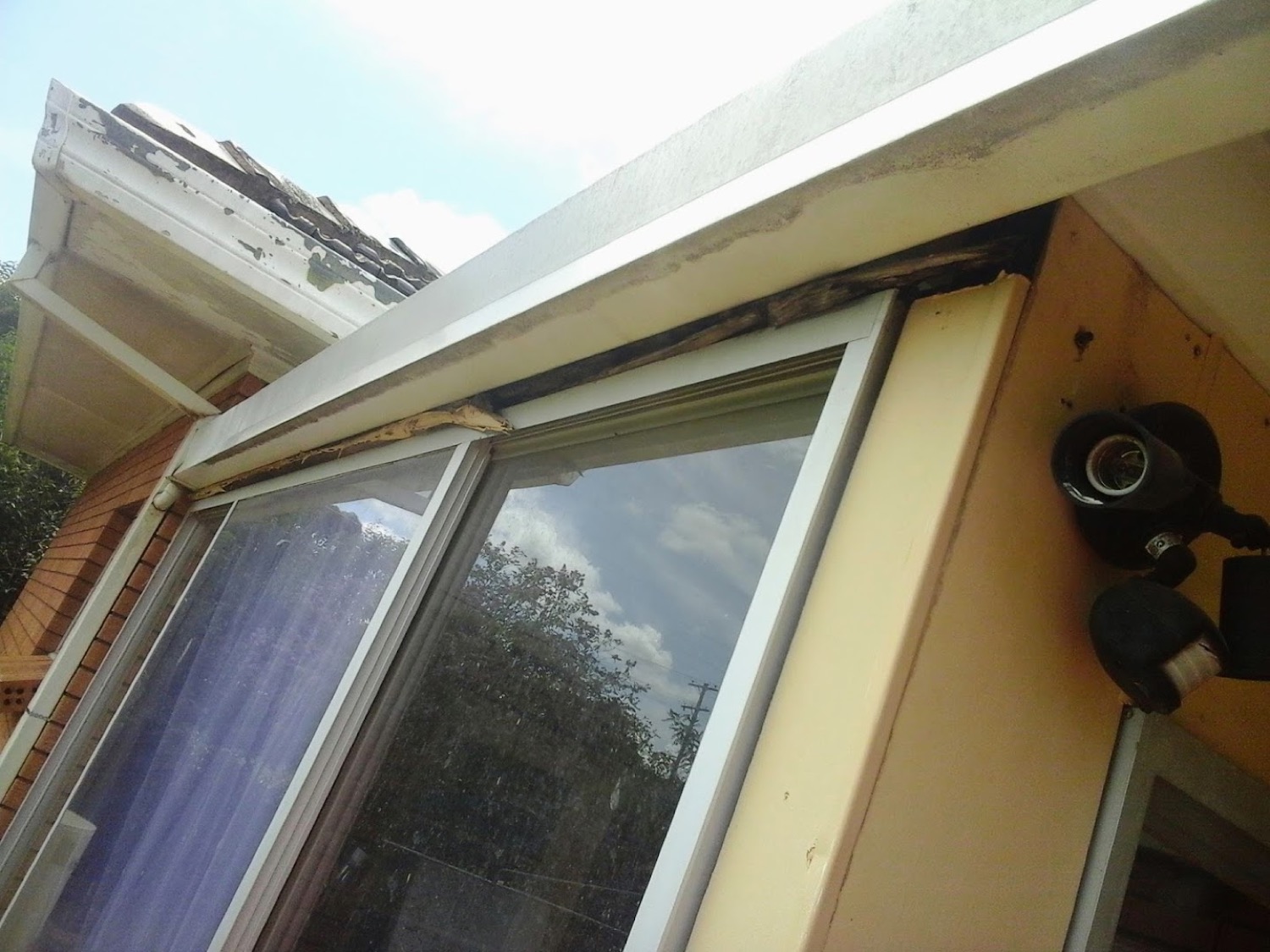 A new window unit being fitted into a timber-framed opening